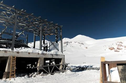 A cable car station under construction high in the mountains in winter. Focus on Stock Photos