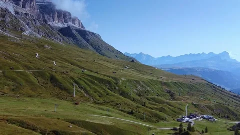 Cable car transporting passengers over grassy slopes in the Dolomites Italy Video stock 342510103
