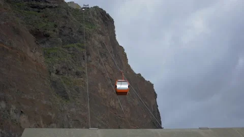 Cable car transporting people through a cliff Stock Footage 222605665