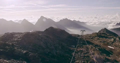 Cable car view of rocky mountain ground, beautiful snowy mountain range 動画素材 153423458
