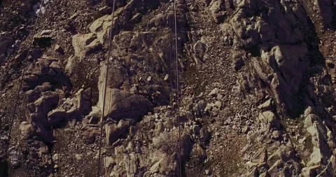 Cable car view of rocky mountain ground, beautiful snowy mountain range 動画素材 153833543