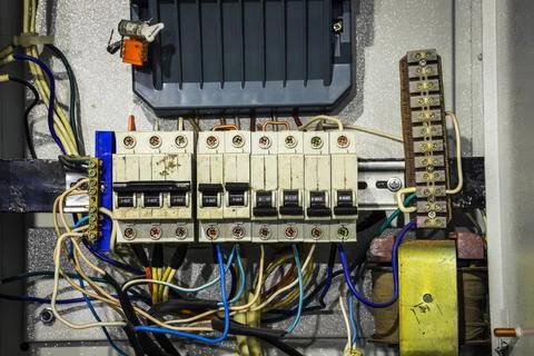 Cable chaos in electric control panel close-up. Tangled wires Foto stock