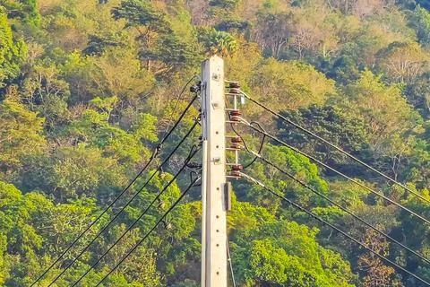 Cable clutter on a power pole in town city Thailand. Stock Photos