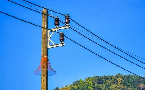 Cable clutter on a power pole in town city Thailand. Stock Photos