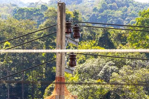Cable clutter on a power pole in town city Thailand. Stock Photos