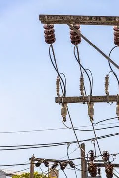 Cable clutter on a power pole in town blue sky. Stock Photos
