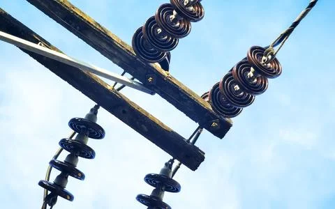 Cable clutter on a power pole in town blue sky. Stock Photos