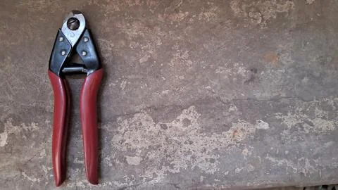 Cable cutter tool on concrete background. Professional wire cutting pliers for Stock Photos