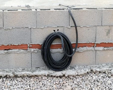 Cable exit secured in constructed brick wall demonstrating electrical insta.. Stock Photos