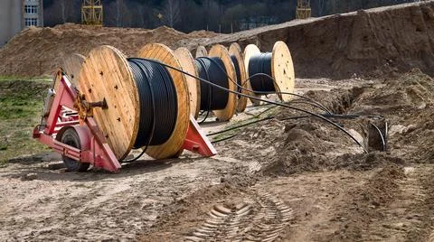 Cable high voltage electric in roll or round coil on ground. Concept of Stock Photos