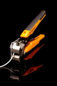 Cable insulation stripping tool isolated on black Stock Photos