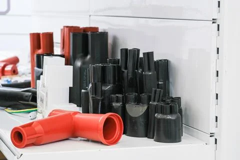 Cable joint accessories displayed on shelf. Selection of heat shrink tubing and Stock-Fotos