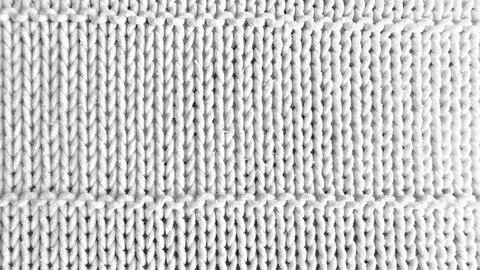 Cable knit white fabric texture closeup with soft intricate twisted yarn patt Stock Photos