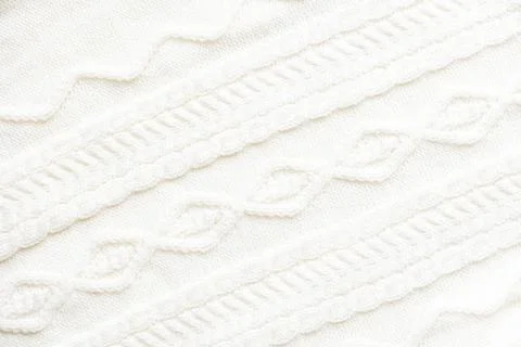 Cable knitting stitch pattern, soft woolen texture, handmade knitted cloth.Huggy Stock Photos