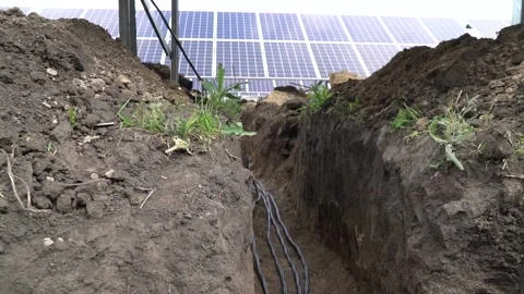Cable laying at a solar power station, view of the solar panels and trenches Stock Footage 160113200