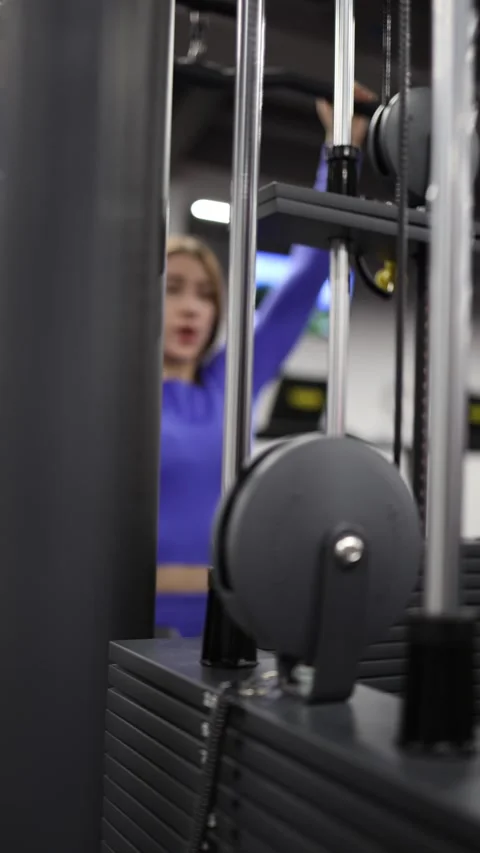 Cable machine strength exercise inside modern gym Stock Footage 328253744