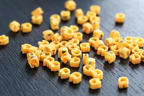 Cable markers scattered on the table, macro shot. Stock Photos