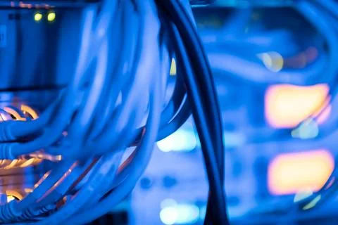 Cable of network cabinet in blue light with red diodes shining Stock Photos
