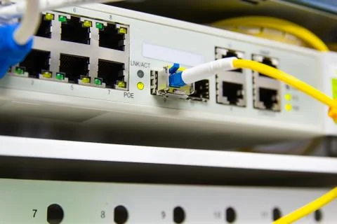 Cable network , fiber optic cable connect to switch port in server room Photos