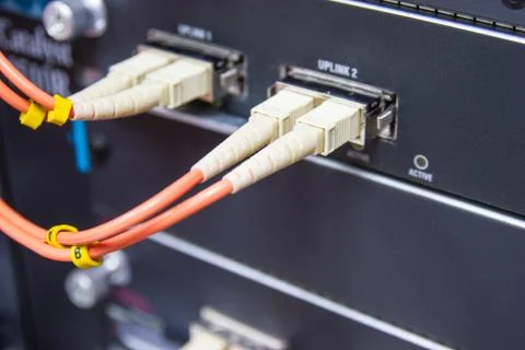 Cable network , fiber optic cable connect to switch port in server room Stock Photos