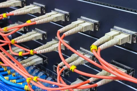 Cable network, fiber optic cable connect to switch port in server room Stock Photos