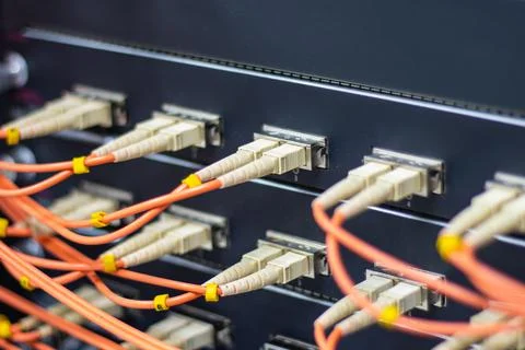 Cable network, fiber optic cable connect to switch port in server room Stock Photos