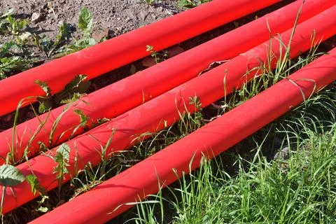 Cable protective pipe lying on the ground Stock Photos