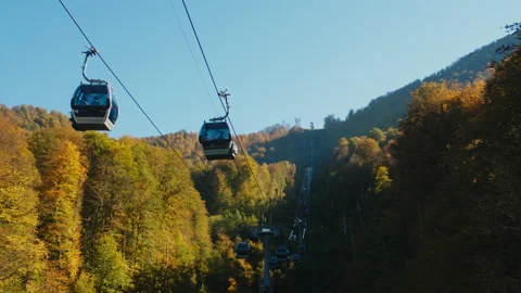 Cable road in sunny day surrounded by gorgeous autumn forest. funicular cabins Stock Footage 204052845