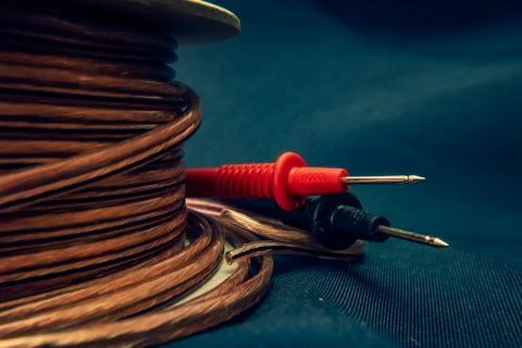 Cable roll isolated on dramatic background with volt meter tester Stock Photos