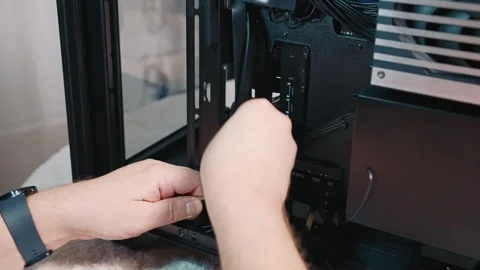 Cable routing in case for clean cable management during PC assembly Stock Footage 325809342