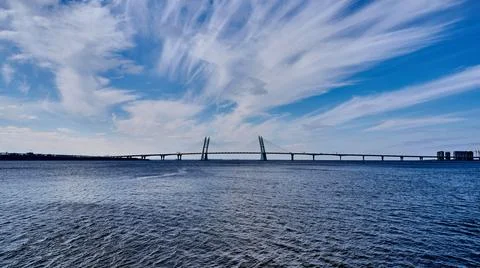 Cable-stayed bridge across the Neva River against the blue sea and sky with Stock Photos