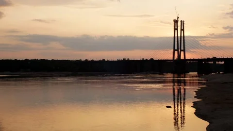 Cable-stayed bridge across the river at sunset Stock Footage 245187519