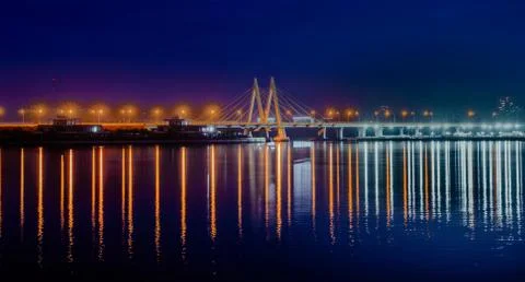 Cable-stayed bridge across the river. The bridge with night lighting in Kazan Stock Photos
