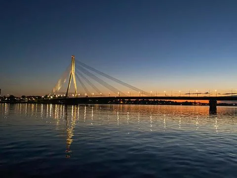 Cable-stayed bridge across the river. The bridge with night lighting. Stock Photos