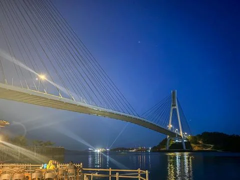 Cable-stayed bridge glows against deep blue sky Stock Photos
