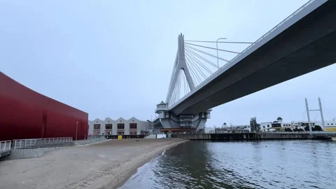 Cable-stayed bridge over Aomori Bay with waterfront promenade and sandy beach Stock Footage 309524335