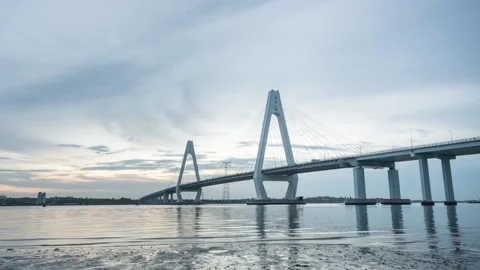 Cable stayed bridge with white pylons over calm water at dusk in Haikou Hainan Stock Footage 348271883