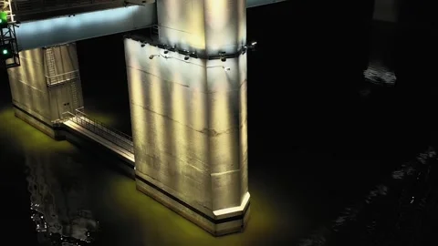 A cable-stayed highway bridge with tall concrete pylons illuminated by Stock Footage 257700281