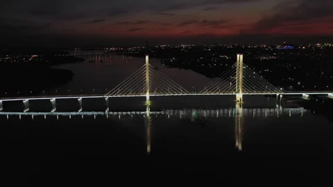 A cable-stayed highway bridge with tall concrete pylons illuminated by Stock-Footage 257700572