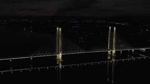 A cable-stayed highway bridge with tall concrete pylons illuminated by Stock Footage 257701136