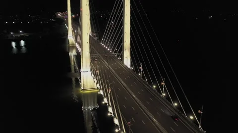 A cable-stayed highway bridge with tall concrete pylons illuminated by Stock Footage 257701612