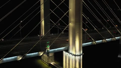 A cable-stayed highway bridge with tall concrete pylons illuminated by Video stock 257702152