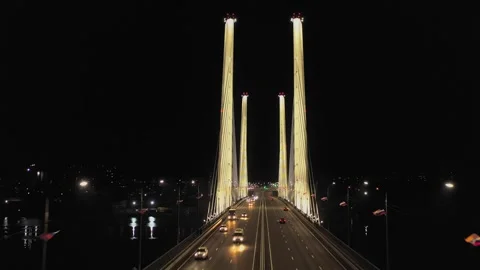 A cable-stayed highway bridge with tall concrete pylons illuminated by Stock Footage 257702738