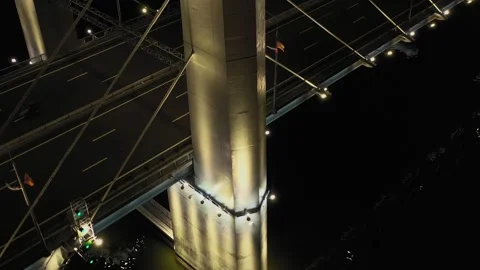 A cable-stayed highway bridge with tall concrete pylons illuminated by Stock Footage 257702863