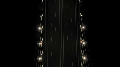 A cable-stayed highway bridge with tall concrete pylons illuminated by Stock Footage 257768102