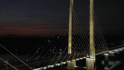A cable-stayed highway bridge with tall concrete pylons illuminated by Stock Footage 257770075