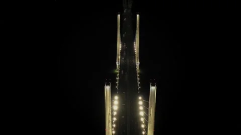 A cable-stayed highway bridge with tall concrete pylons illuminated by Stock Footage 257775484