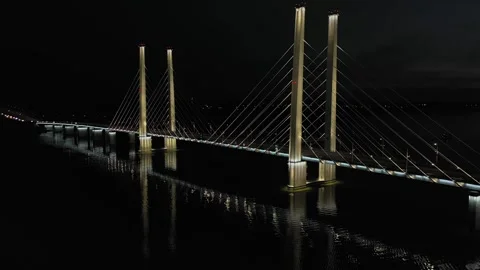 A cable-stayed highway bridge with tall concrete pylons illuminated by Video stock 257780749