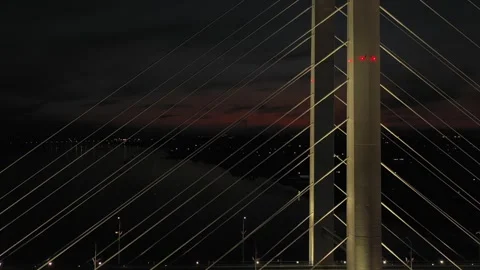 A cable-stayed highway bridge with tall concrete pylons illuminated by Stock Footage 257784888