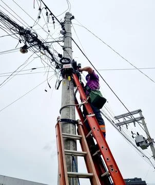 Cable technician on pole Stock Photos